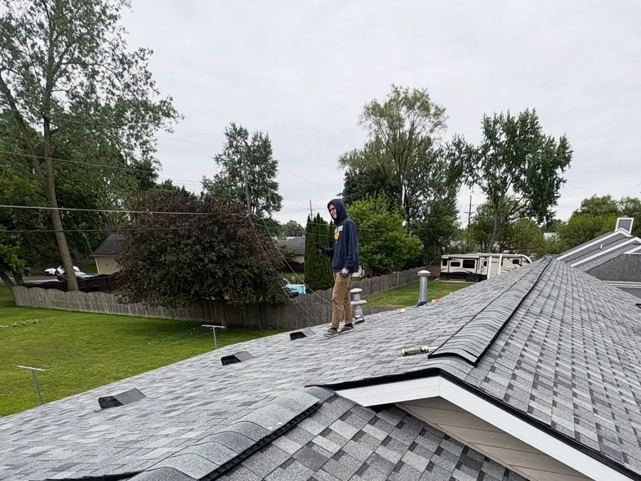 A finished grey architectural shingle roof with clean valleys and hips.