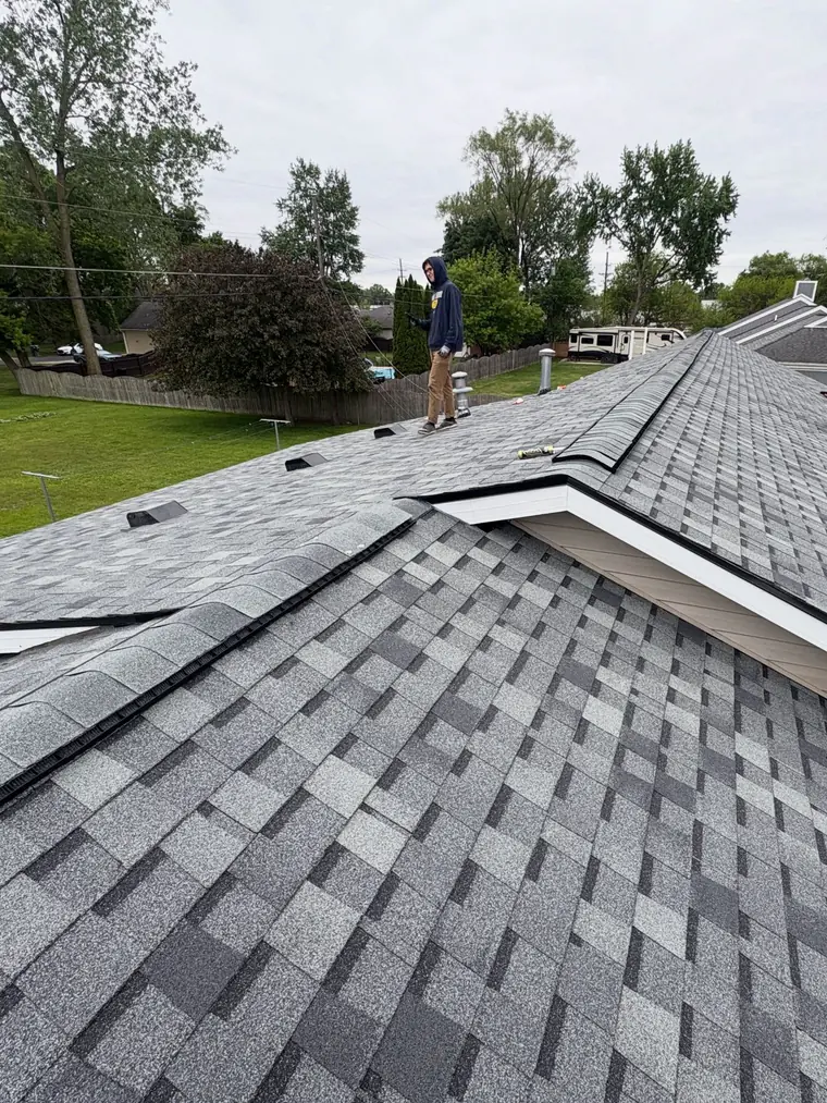 A finished grey architectural shingle roof with clean valleys and hips.