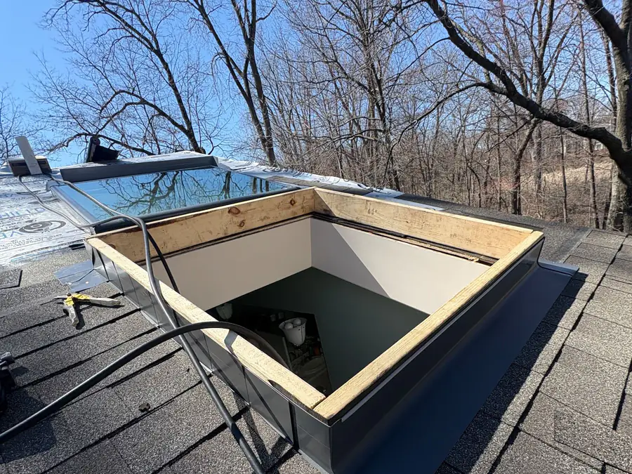 A framed skylight curb with new step flashing waiting for the glass unit.
